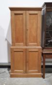 Oak cupboard with moulded cornice above two panelled doors enclosing shelves, the base with two