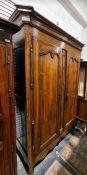 19th century French armoire with moulded cornice above two panelled doors enclosing hanging space