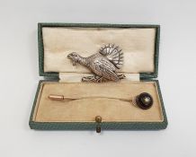 Gold-coloured stickpin, the banded onyx head set with a central diamond and a silver brooch of a