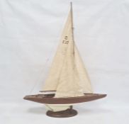 Varnished and painted wood model yacht with canvas sails and the associated wooden stand, 102cm high