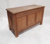 20th century oak coffer, rectangular top with moulded edge, three panels to the front, shaped