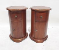 Pair of modern drum-shaped bedside tables, the cylindrical tops with moulded edge above single