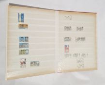 A red stamp album of assorted world stamps