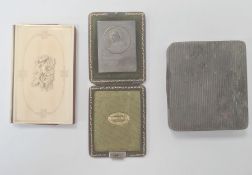A Dunhill silver coloured metal cigarette case, a travel icon in green leather case 'Salvator Mundi'