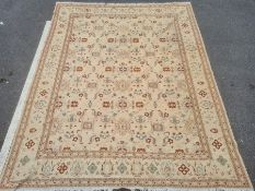 Large modern cream ground rug, the central field with repeating pattern, 367cm x 286cm