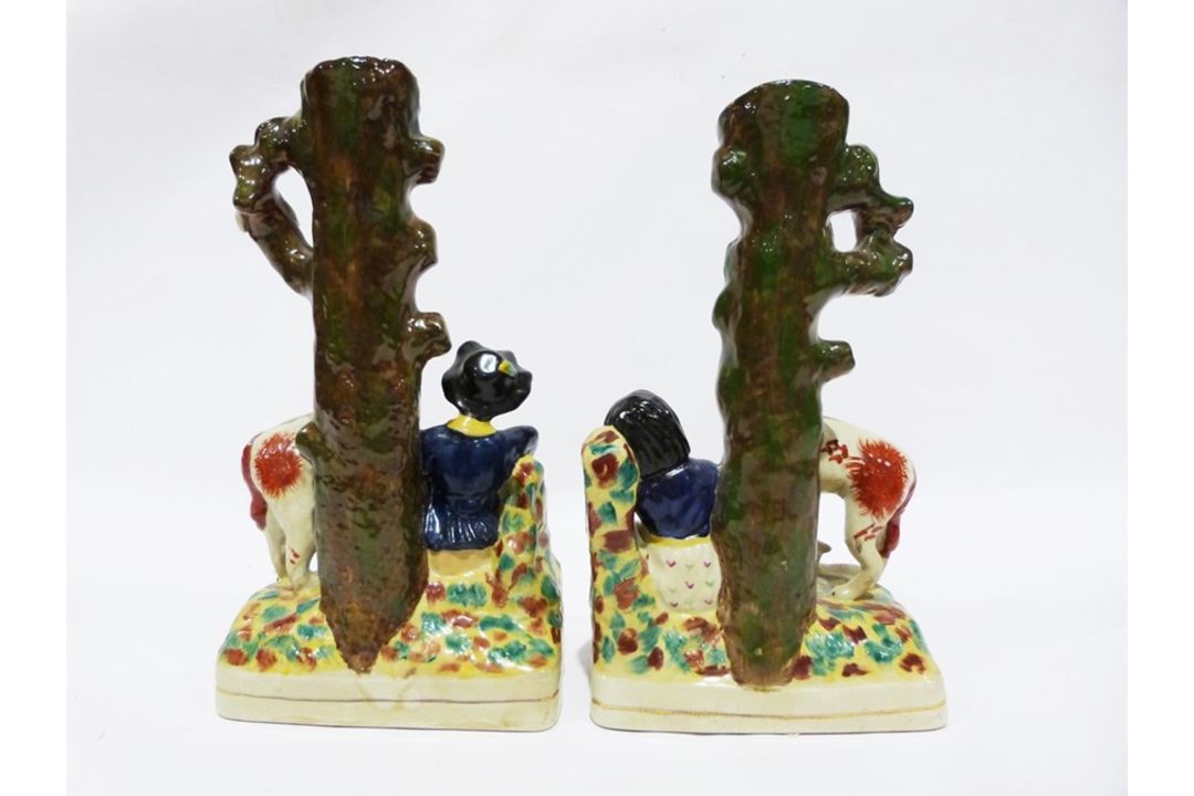 Pair of reproduction Staffordshire vases, the bases of each modelled with a seated figure surrounded - Image 2 of 2