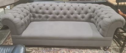 Late Victorian Chesterfield sofa in grey button back upholstery, on turned front legs to brown china