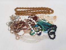 Quantity of costume jewellery including long string of bakelite beads, carved bone beads,