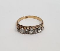 Gold carved head ring set with three graduated mixed cut diamonds interspersed by two pairs of
