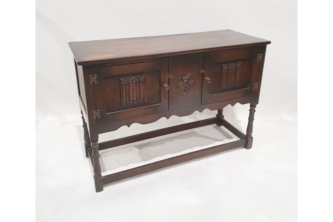 20th century oak sideboard with two linenfold decorated doors, on turned supports and stretchered