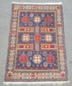 Modern Eastern-style rug, the blue ground field with nine octagonal motifs, in blues, reds,