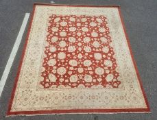Modern Eastern-style rug, red ground with cream allover foliate decoration, cream ground border,