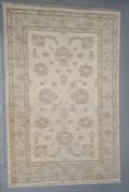 Modern cream ground Eastern-style rug with foliate decoration, 148cm x 93cm