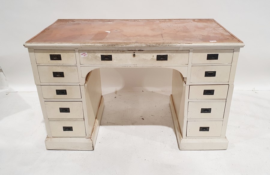 Early 20th century white painted pedestal desk, with campaign-style handles, 11 assorted drawers, on