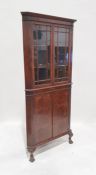 20th century walnut corner display cupboard with two astragal-glazed doors enclosing shelves, two