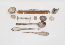 Assorted silver items to include a silver-mounted comb, a salt, a thimble, a duck-shaped silver-