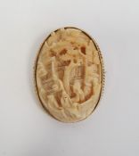 Late 19th/early 20th century carved ivory brooch of oval form depicting figures beneath a tree, in