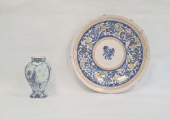 Delft inverse-baluster vase and a maiolica charger with stylised foliate spray to centre, blue