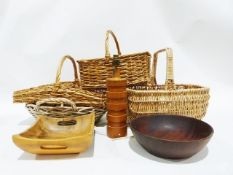 Four assorted wicker baskets, a turned wooden table lamp base and two wooden bowls