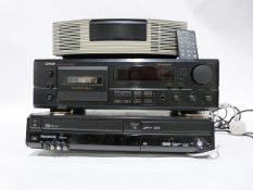 Bose radio alarm clock, a Denon cassette player and a Panasonic VHF player