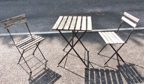 Slatted wood and black metal folding small garden table and pair matching chairs