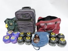 Box of assorted bowling trophies and a set of Thomas Taylor bowls in carrying bag and two other sets