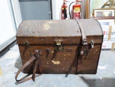 Vintage trunk with domed top and leather handles and straps, the locks bearing patent number and