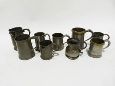 Quantity of pewter mugs, 19th century and later, one with engraved name and another with spout