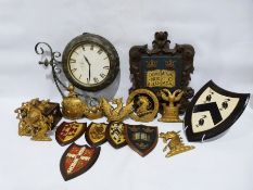 Double-sided vintage-style metal-framed clock, a carved wood armorial crest, assorted other gilt