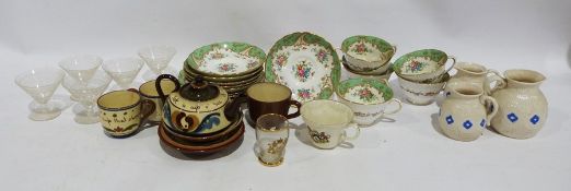 Tuscan china cups and saucers, the interior decorated with flowers and a green border, Devonware