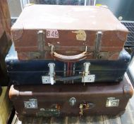 Brown suitcase with Royal Mail London Ltd label (torn), Orlean Paris label and two other