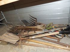 Large collection of garden tools to include four spades, pickaxe, etc