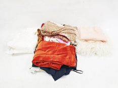 Quantity of textiles and clothing including a pair of orange velvet trousers, a paisley skirt, a