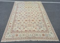 Kelim carpet decorated allover with stylised flowerheads in blue, rust and green, on a cream ground,
