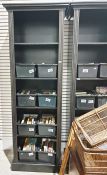 Two black painted open bookcases, the moulded cornices above the shelves, each on plinth base, 219cm