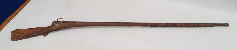 Old musket with wooden stock and barrel and metal mounts