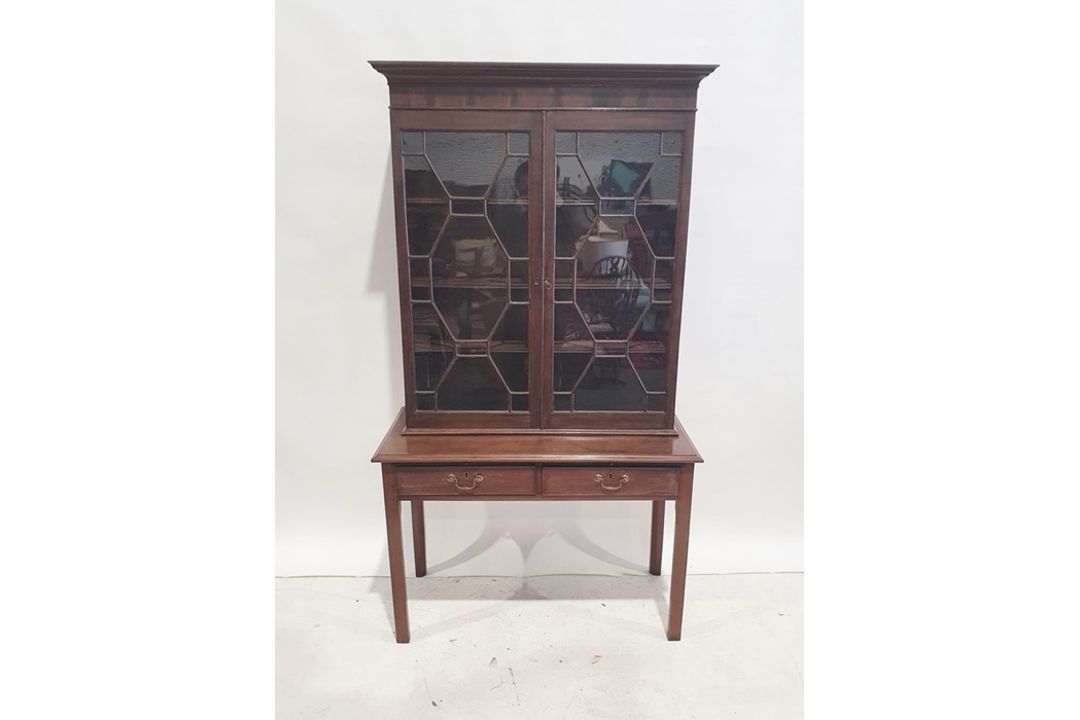 Georgian-style bookcase with ogee moulded cornice, astragal-glazed doors enclosing shelves, the base
