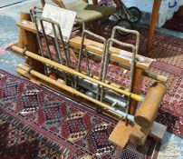 Wooden croquet stand fitted with four mallets by G Bussey & Co, a set of eight metal hoops, four