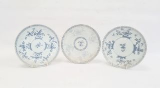 Pair of blue and white plates each decorated with trailing blossom with diaper borders, 22cm