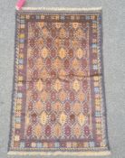 Baluchi rug, the central field decorated with brown lozenges within blue borders and within a floral