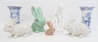 Bisque porcelain figure of a boy seated on a plinth and writing (with damage), 24cm high, two blue