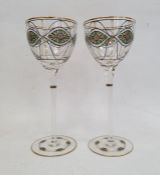 Pair of wine glasses on slender stems in the manner of Theresienthal, the bowls and feet painted