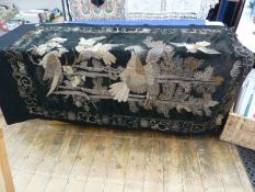 An antique Eastern embroidered wall hanging, black ground with silvered and gilt thread decoration