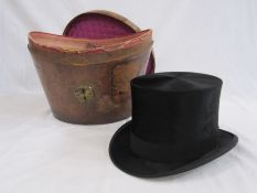 Black top hat labelled Lincoln Bennet & Co with a leather hatbox with various labels and