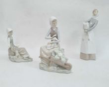Lladro figure of a girl holding a lamb, 27cm high, a Lladro model of a seated girl with lamb and a