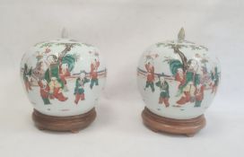 Pair of 19th century Chinese jars and covers of spherical form, decorated with continuous scenes