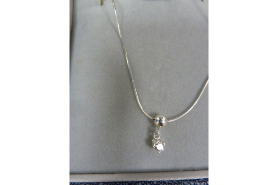 Solitaire diamond drop pendant, claw-set in silver mount, on fine chain, the stone approx 0.10ct - Image 1 of 4