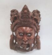 Chinese carved hardwood mask depicting a man's face, with his headdress surmounted by dragons,
