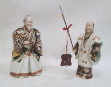 Japanese porcelain figure of a man in robes holding a sword and another figure holding a spear, 24cm