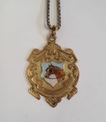 9ct gold medallion set pendant painted with shield of horse's head 